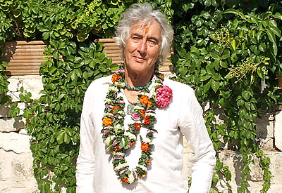 Visionary artist, author, Earth Day and Whole Earth Festival founder, José Argüelles is seen wearing a lai of flowers