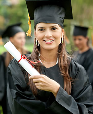 Latina college student with degree in hand at commencement ceremony