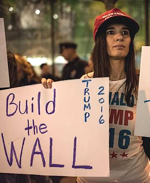 Donald Trump supporter holds a Build The Wall sign