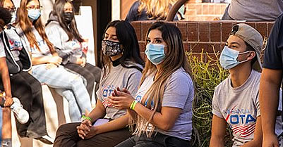 Young Latino voters with protective face masks