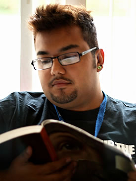 young Latino student reading
